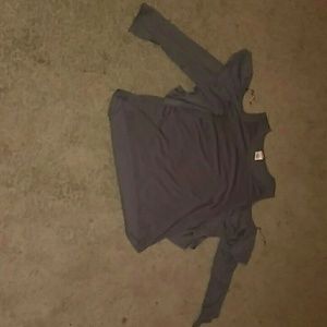 A grey shirt with shoulder cut outs and ruffles